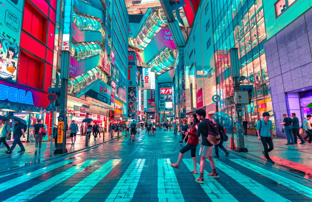 People walking on the road near brightly lit buildings