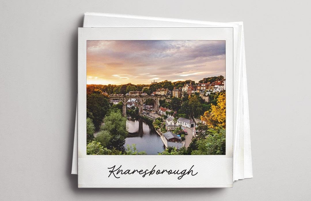 A polaroid photo of the Knaresborough viaduct at sunset.