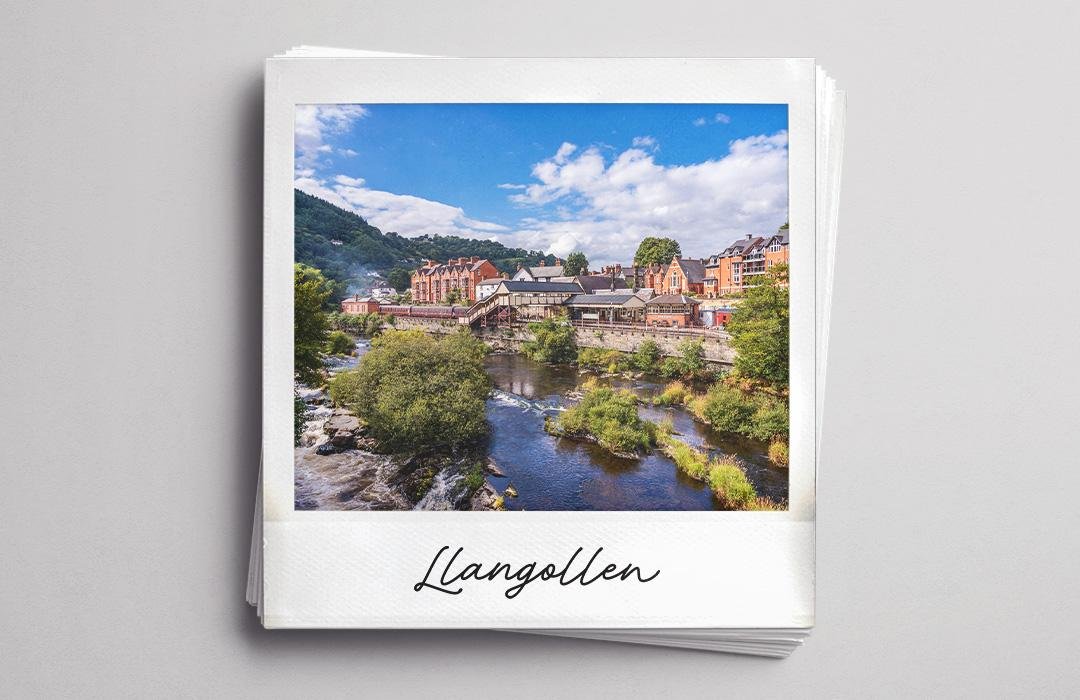 A polaroid photo of Llangollen, a Welsh town on a rocky river.
