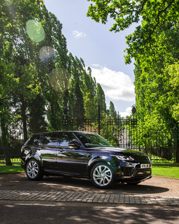 Range Rover Sport from the side with trees and greenery